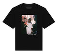 Black t-shirt with a graphic of a person in a cityscape and text on a white background