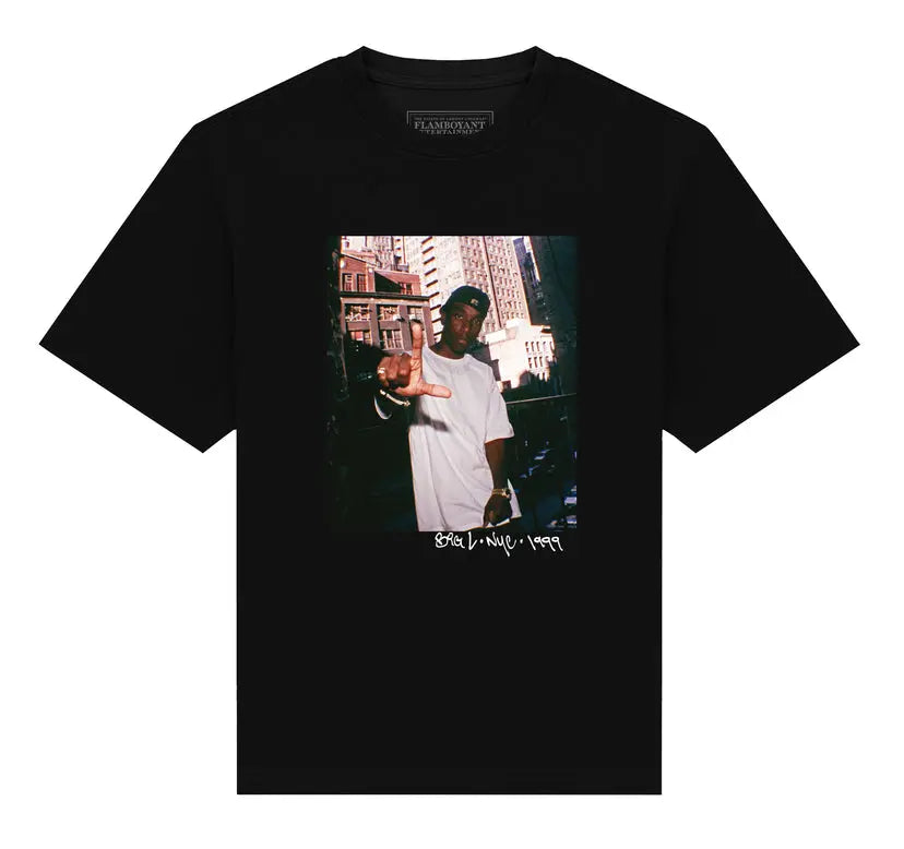 Black t-shirt with a graphic of a person in a cityscape and text on a white background