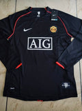 Black sports jersey with visible branding on a tiled floor