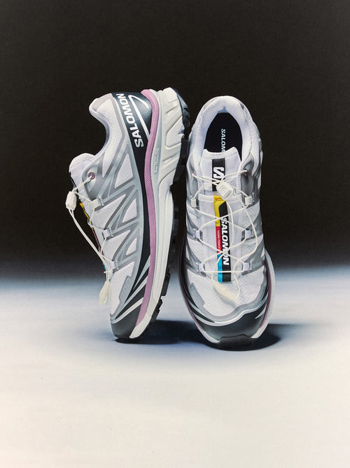 Pair of Salomon running shoes on a black and white background