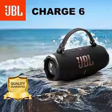 JBL Charge 6 Bluetooth speaker on a rocky shore with ocean waves in the background