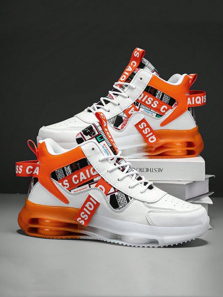 White sneakers with orange and black accents on a dark background