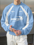 Person wearing a blue and white sweatshirt with 'Sincere' branding.
