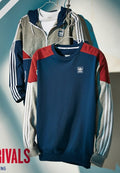 Adidas sweatshirt with color-block design on a hanger against a gradient background